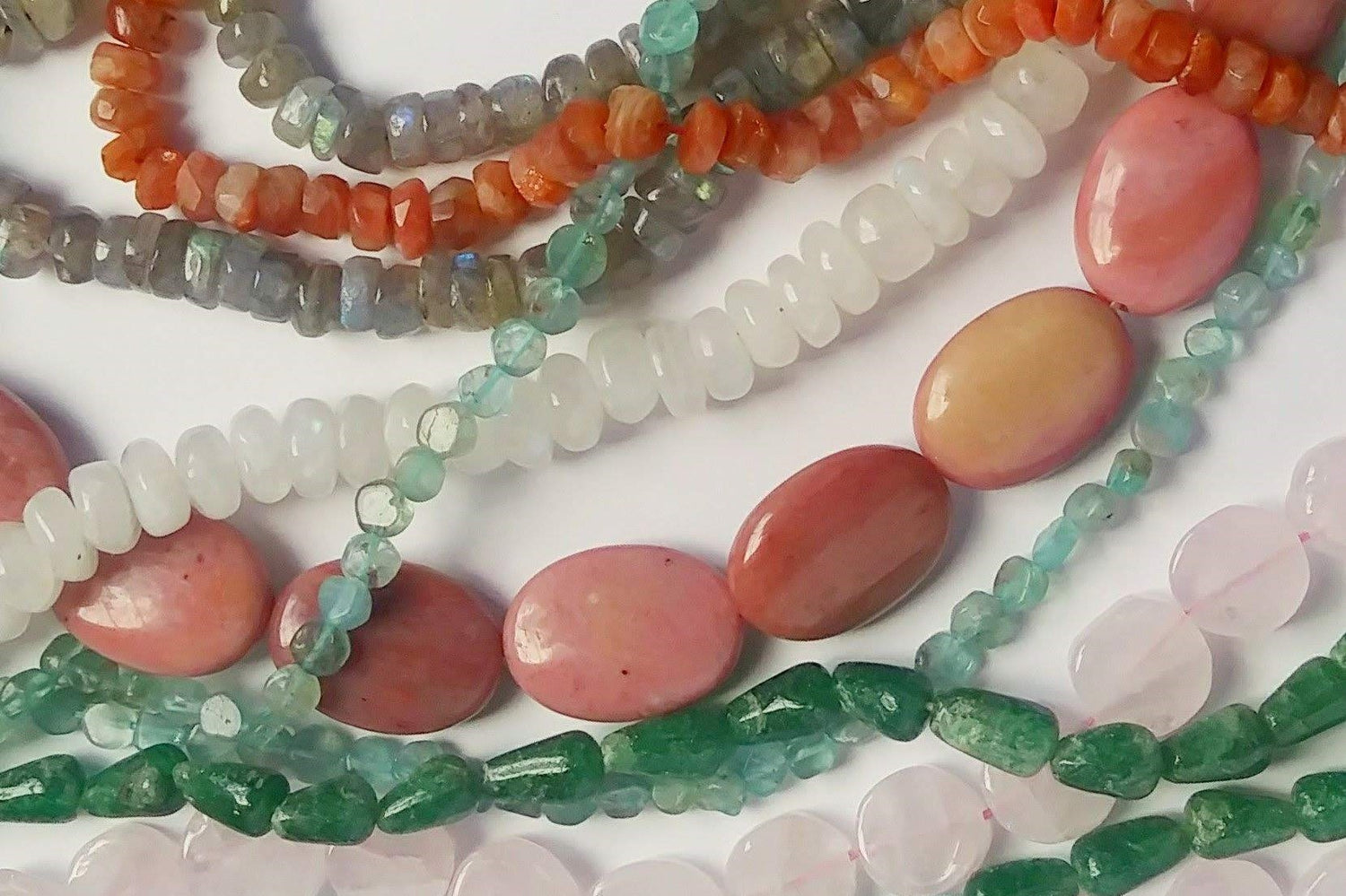 natural gemstones of various colors, shapes, and sizes